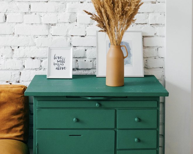 A green cabinet with drawers